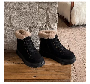 Warm black faux fur lined snow boots with thick soles and lace-up design in a cozy setting