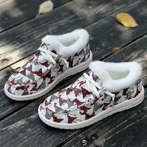 Close-up of women's Christmas gnome print loafers with soft white faux fur lining on wood.