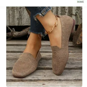 Stylish and breathable brown knitted round-toe flats for women on rustic wooden deck