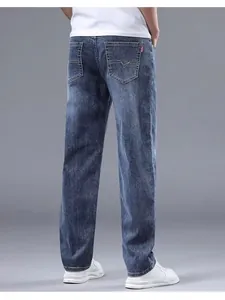 Detailed back view of men's relaxed straight-leg blue jeans featuring pocket stitch detail.