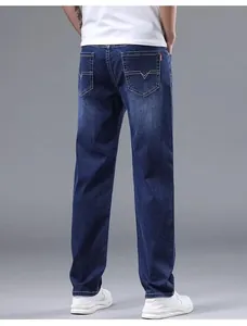 Detailed rear view of classic men's dark blue straight-leg loose fit casual denim jeans