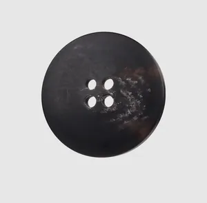 Macro detail of a high-end dark marbled resin button with four holes for coats and jackets