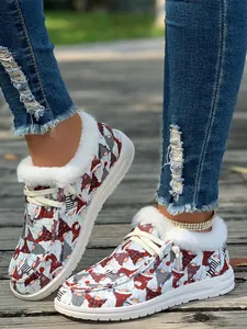 Close-up of women's Christmas gnome printed fleece-lined shoes on a wooden boardwalk