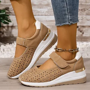 Close-up of lightweight khaki laser-cut wedge sneakers with a hook-and-loop strap.