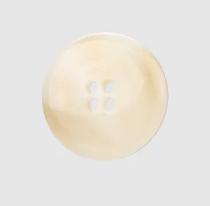 Macro detail of a premium cream resin button showing elegant marble texture for luxury clothing