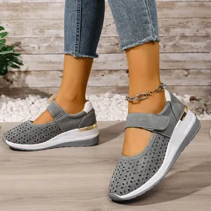 Detail view of breathable grey perforated wedge sneakers with hook and loop strap