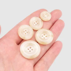 Assorted sizes of high-end beige resin buttons with marbled texture for clothing