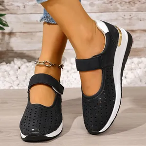Detailed view of breathable black hollowed-out sports wedge shoes with Velcro strap