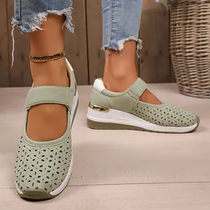 Detailed macro view of breathable sage green perforated Mary Jane shoes with wedge sole