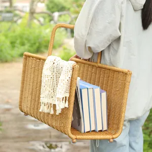 Handwoven imitation rattan storage basket for magazines and books in outdoor setting