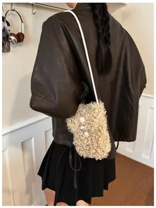 Detailed view of a vintage curly faux fur crossbody phone bag in beige for autumn wear
