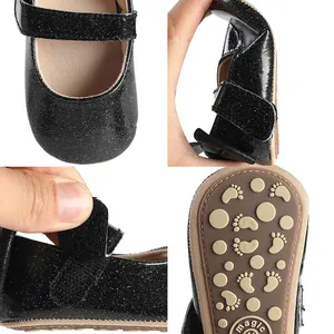 Close-up of black glitter baby walking shoes showing sole and velcro details