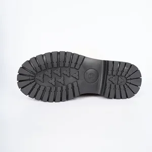 Close-up of black rubber lug sole with traction pattern and size 37 mark for women's boots.