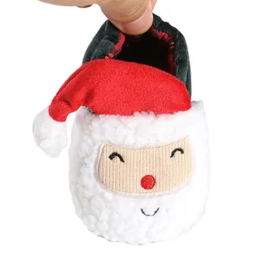 Close-up of Santa Claus themed plush baby winter shoes with soft lining for newborns