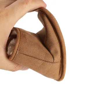 Macro detail showing the flexible sole and warm fleece lining of the brown baby boot.