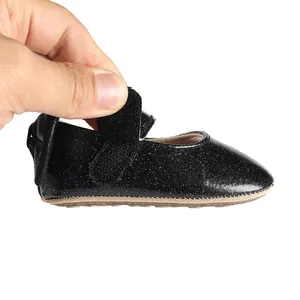 Detail showing the soft glitter fabric and flexible sole of infant walking shoe