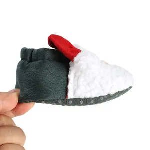 Side profile detail of a festive Christmas-themed baby shoe with fuzzy textures.