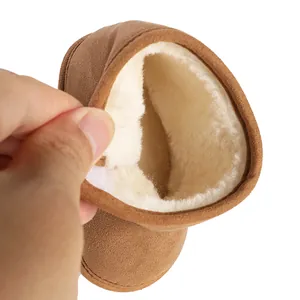 Detailed macro view showing the thick white fleece lining inside a brown baby winter boot