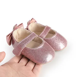 Close-up detail of pink glitter baby shoes featuring cute bow for 3-12 month infants
