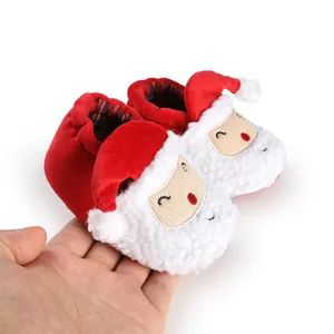 Detailed view of cute Santa Claus cartoon pattern on soft red plush winter baby shoes