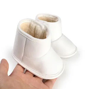 Cozy white winter baby boots with soft non-slip soles and warm faux fur lining details