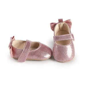 Sparkling pink baby shoes with cute bow detail for infant girls pre-walking stage
