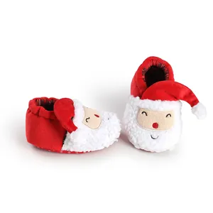 Close-up detail of soft plush Santa Claus cartoon baby winter booties for newborns