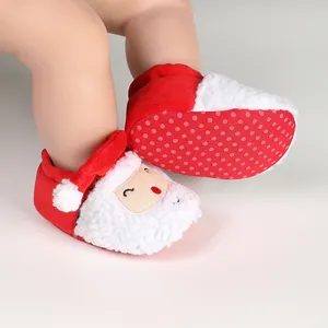 Close-up of baby Christmas Santa Claus winter walking shoes with anti-slip soles
