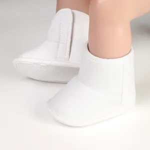 Detail of white infant winter boots with velcro strap and soft anti-slip soles