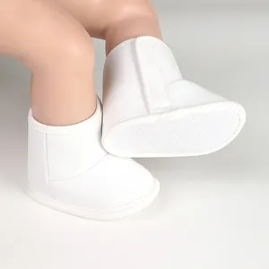 Close-up of white baby winter boots with soft anti-slip sole and velcro closure.