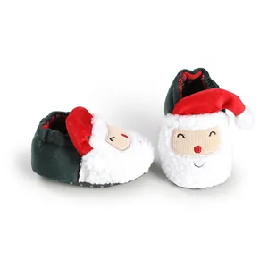 Detailed close-up of cute Santa Claus themed plush baby winter shoes in festive red and green