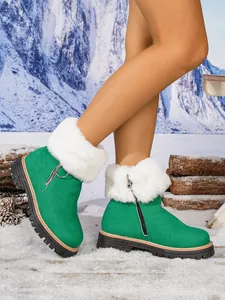 Detail view of stylish women's green snow boots with white faux fur collar and side zipper.