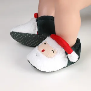 Detail view of plush Santa Claus baby winter boots with anti-slip soles for newborn infants