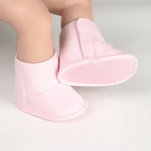 Detail view of pink baby winter boots featuring non-slip soft soles and velcro