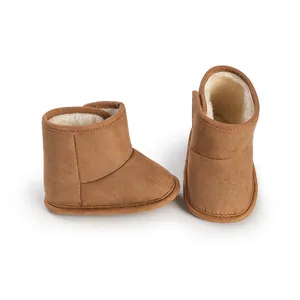 Brown infant winter boots with warm faux fur lining and velcro closure