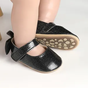 Detailed view of black glitter baby girl walking shoes with non-slip sole for infants.