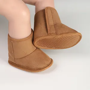 Macro view of brown baby winter boots with textured anti-slip sole and velcro strap.