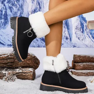 Close-up of black women's winter snow boots with white faux fur and side zipper detail