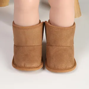 Close-up view of warm brown suede-like baby winter boots featuring soft velvet lining