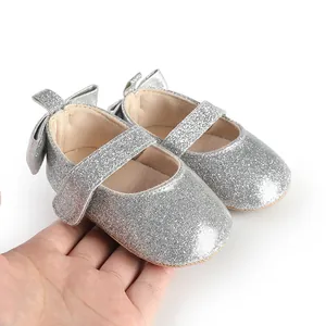 Close-up detail of silver glitter baby Mary Jane shoes featuring a cute heel bow