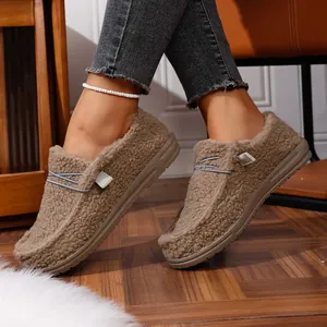 Cozy women's khaki fleece-lined loafers with lace detail shown in home setting