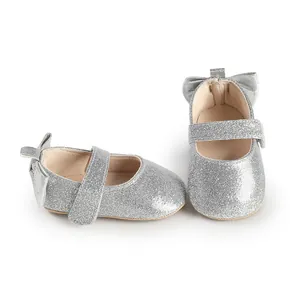 Detailed view of silver glitter baby girl walking shoes with back bow and Velcro strap