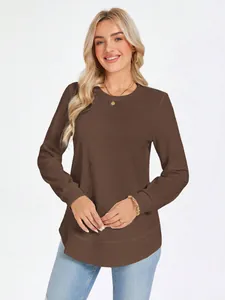 Front view of a brown waffle knit crew neck long sleeve top on a smiling blonde model