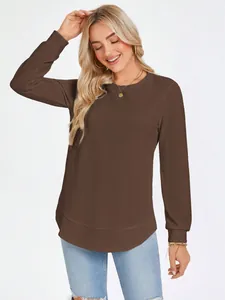 Close-up detail of women's waffle knit long sleeve top in brown with round neck.