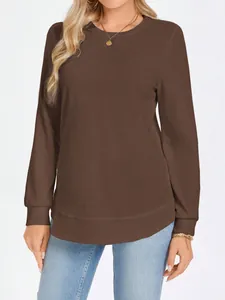 Detailed close-up of brown waffle knit crewneck long-sleeved top for women showing texture