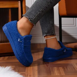 Close-up of cozy blue fuzzy loafers with warm fleece lining and stylish metal buckle.
