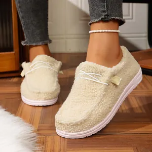 Cozy cream-colored sherpa-lined loafers for winter wear on a model's feet