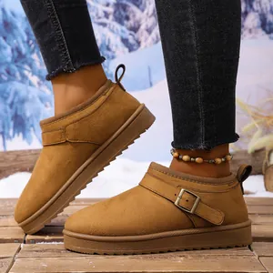 Detailed view of camel faux suede platform snow boots with buckle strap detail