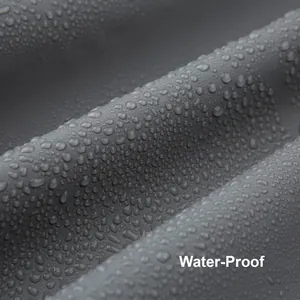 Close-up of waterproof grey PEVA fabric with water droplets showing surface resistance.