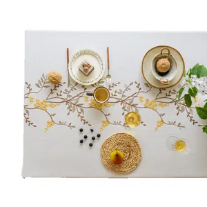 Elegant off-white linen tablecloth with yellow floral embroidery for home dining decor